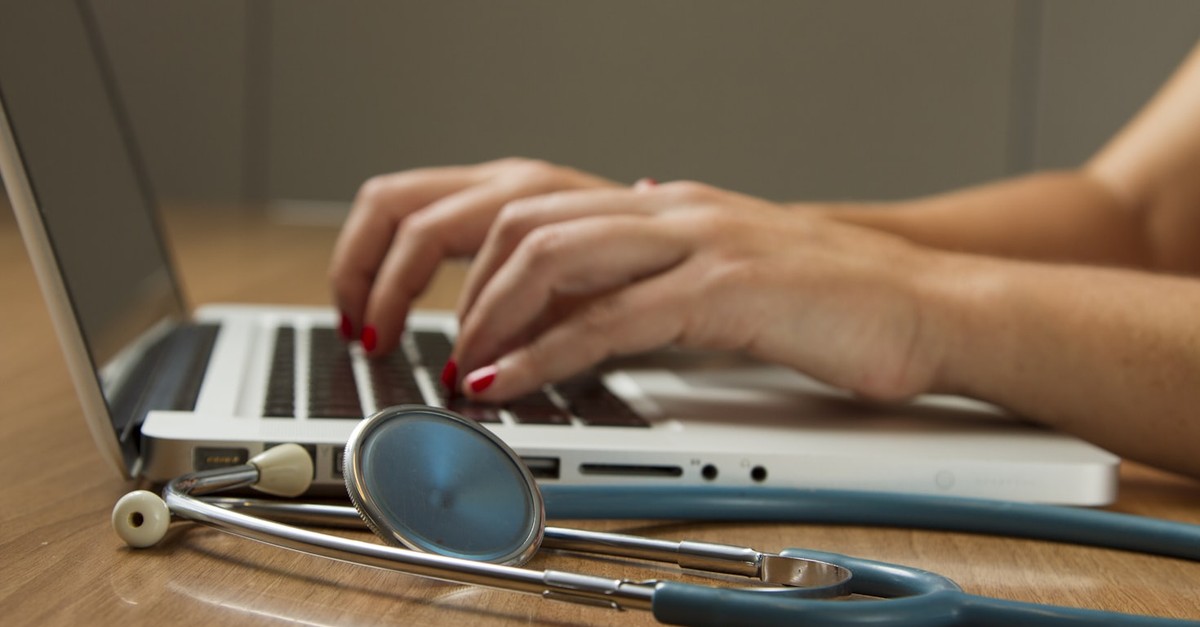 Doctor with stethoscope and laptop: digital health applications in standard care